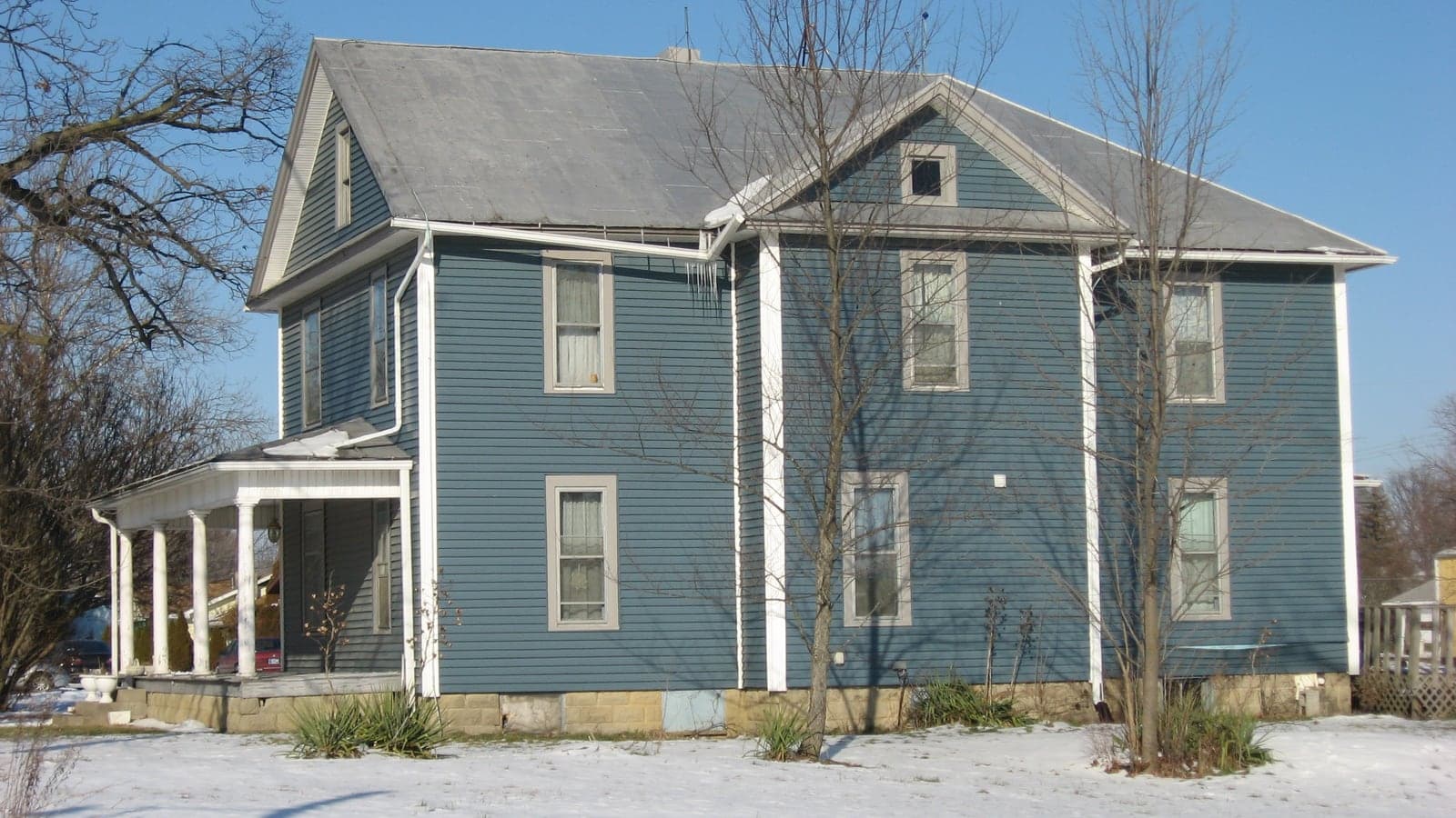 Sample house: Two-story farmhouse with lap siding and a metal roof