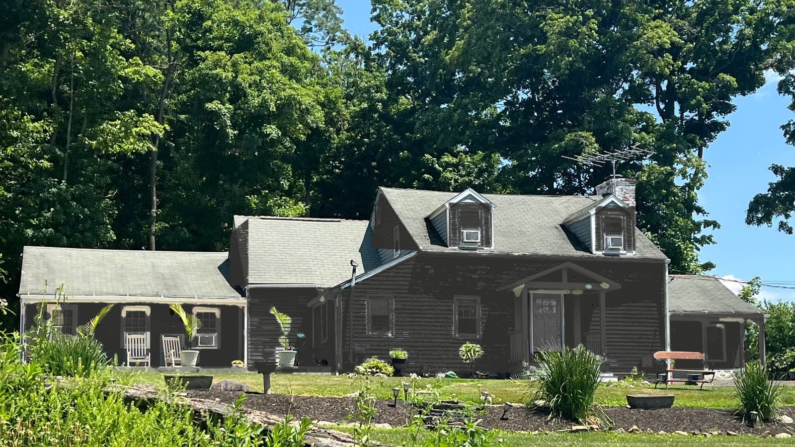 Cape Cod with lap siding and two dormers, repainted: siding Iron Ore SW 7069, trim Iron Ore SW 7069, front door Peppercorn SW 7674