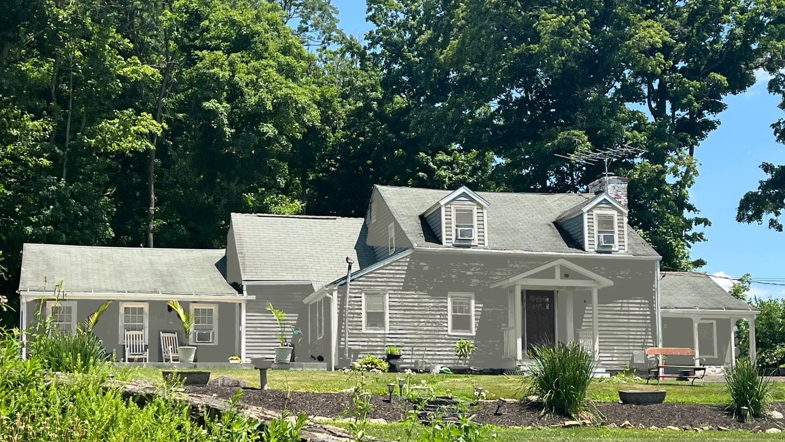 Cape Cod with lap siding and two dormers, repainted: siding Evergreen Fog SW 9130, trim Alabaster SW 7008, front door Tricorn Black SW 6258