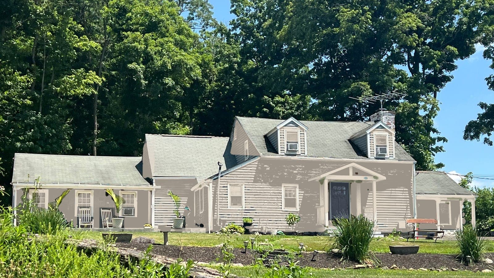Cape Cod with lap siding and two dormers, repainted: siding Accessible Beige SW 7036, trim Alabaster SW 7008, front door Hale Navy HC-154